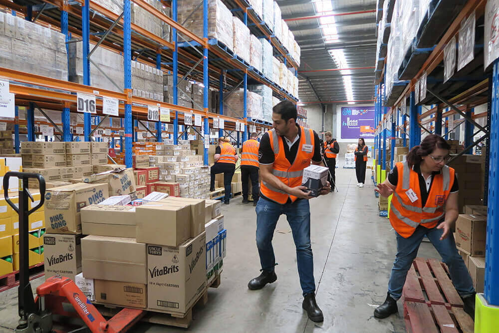 La Trobe Financial staff volunteering moving boxes in a warehouse