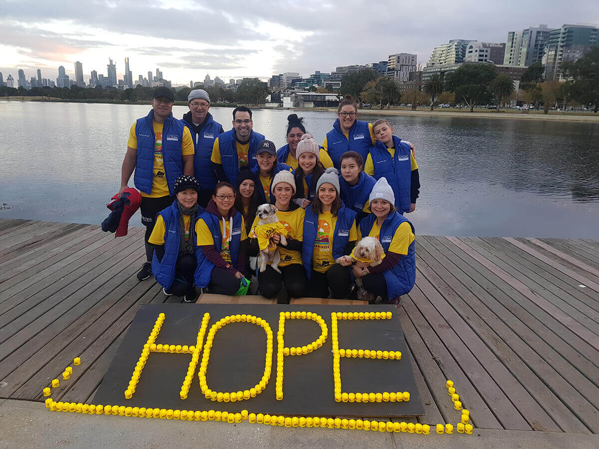 La Trobe Financial staff with hope sign on ground